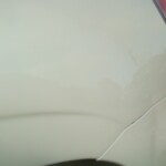 Before and after photographs of a damaged white Subaru that was repaired by Elite Paint & Body Shop in West Palm Beach, Florida